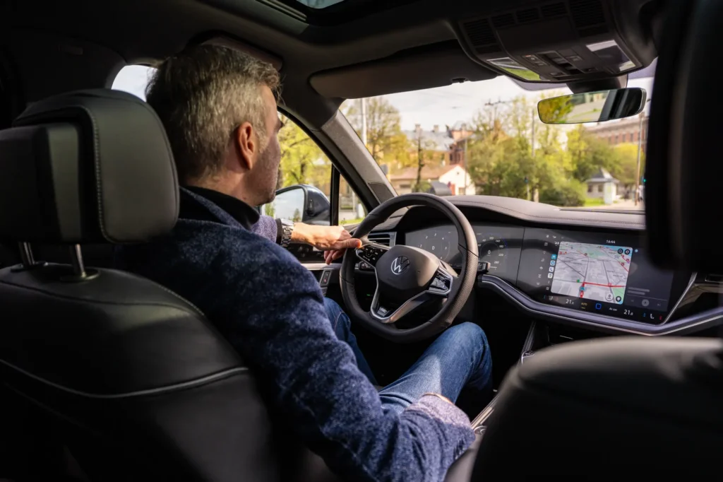 Man driving after recovering from rotator cuff surgery