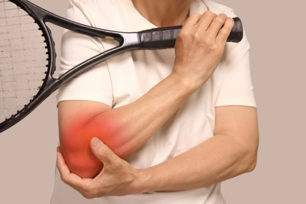Man holding elbow with pain, Tennis racket