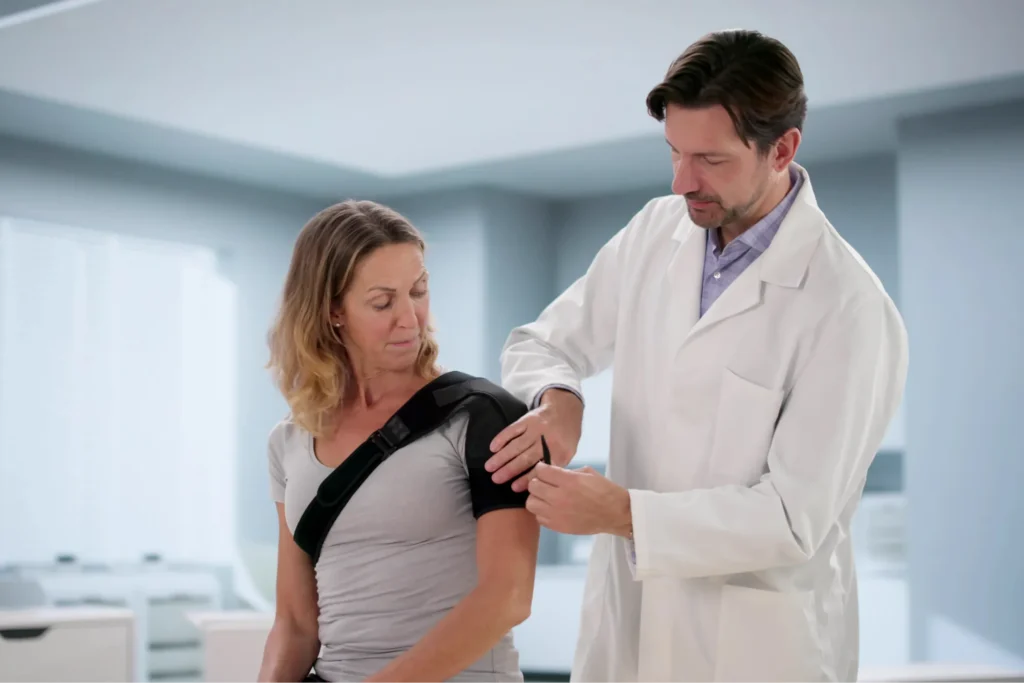 Orthopedic doctor examining a person who just had a shoulder arthroscopy