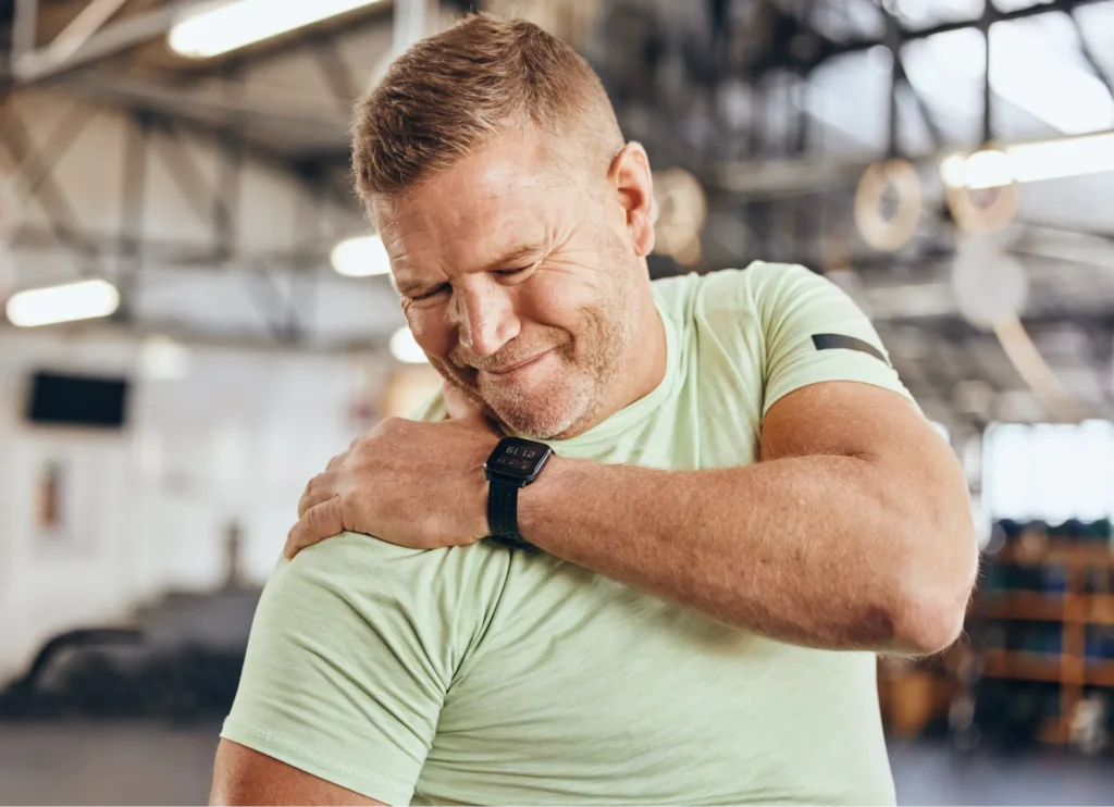 Patient holding shoulder with arthritis.